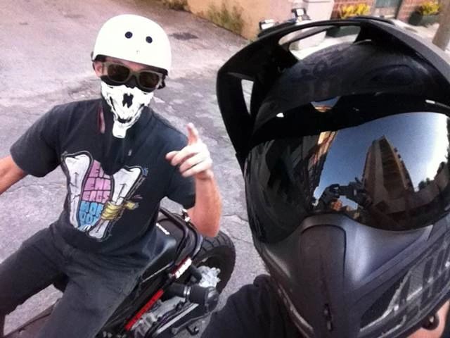 Phillip and a friend on scooters, helmets on