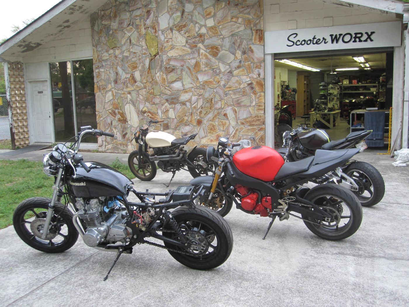 Custom bike builds parked outside Scooter WORX, circa 2013